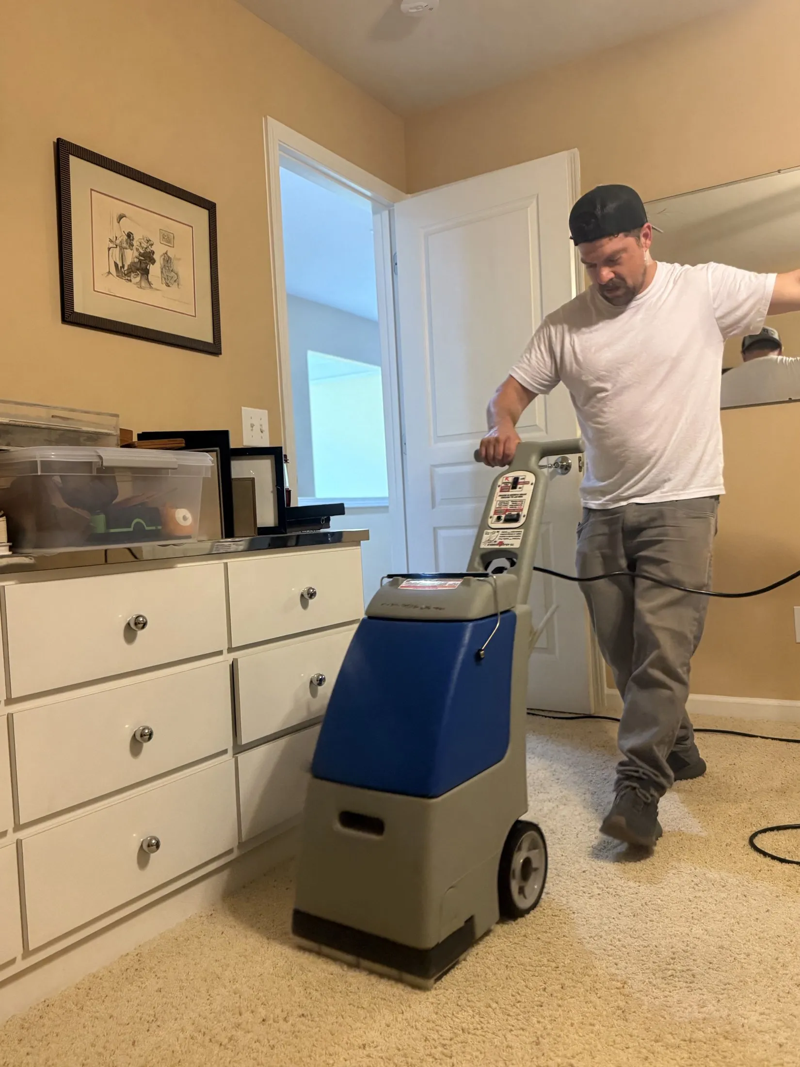 A Carolina Pro Restoration technician extracting water from carpet in an Indian Land, SC home