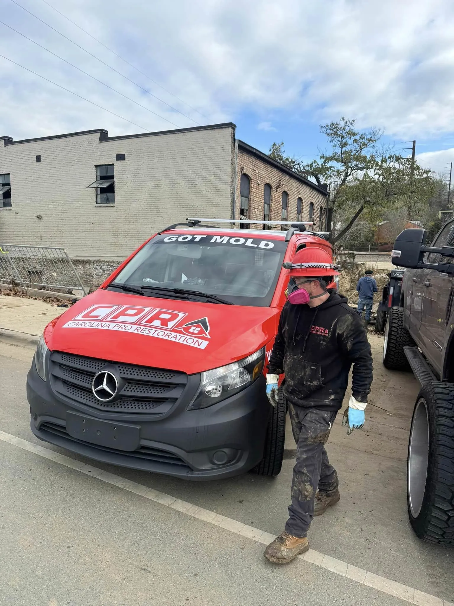 A Carolina Pro Restoration technician beside the branded company van on a job in the Charlotte, NC metro