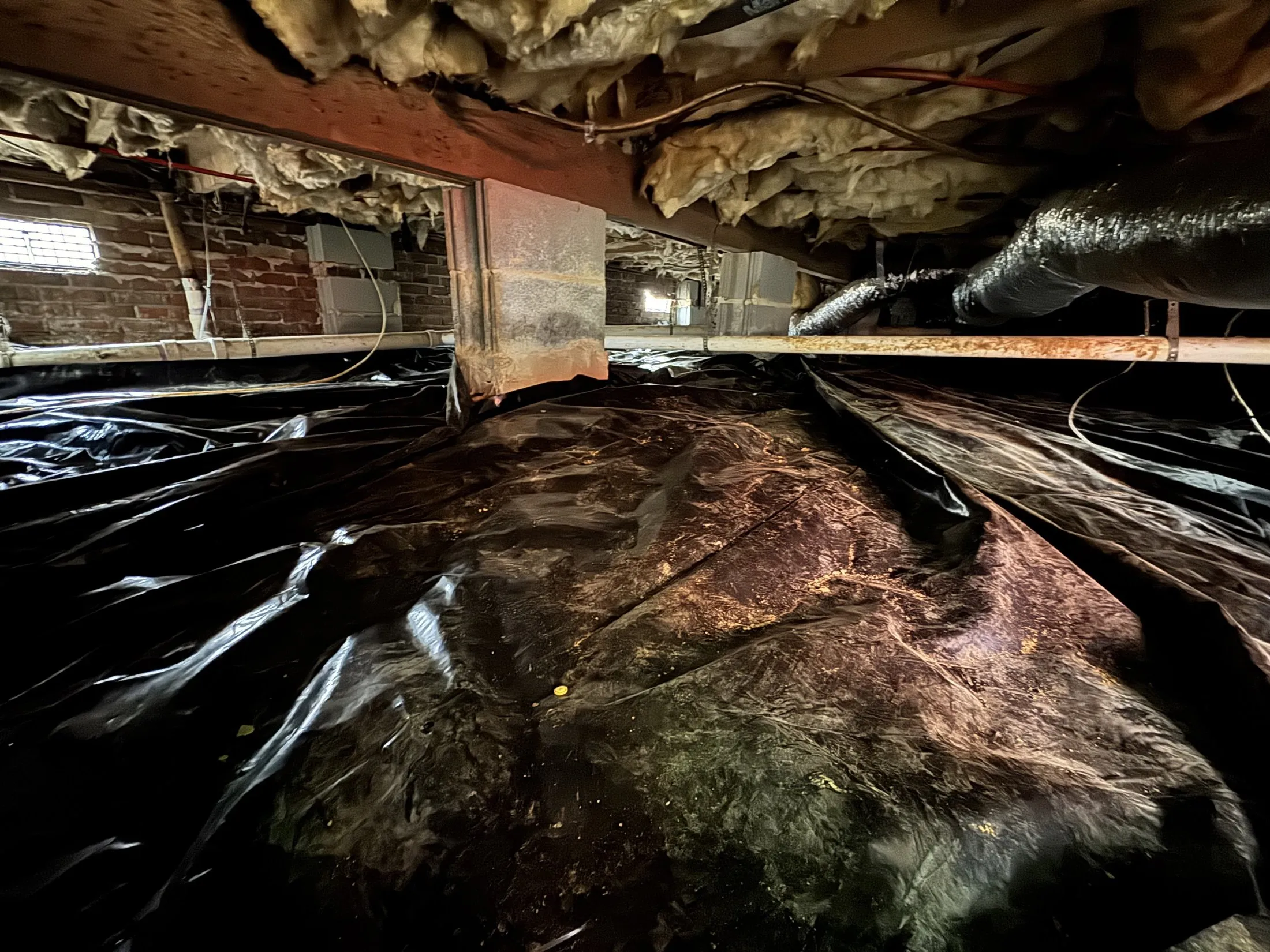 Wet crawl space being waterproofed