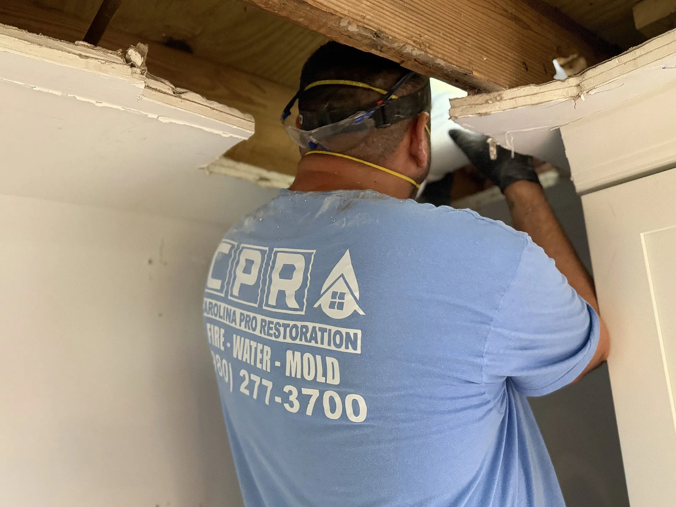 A Carolina Pro Restoration technician rebuilding a wall during an insurance reconstruction project